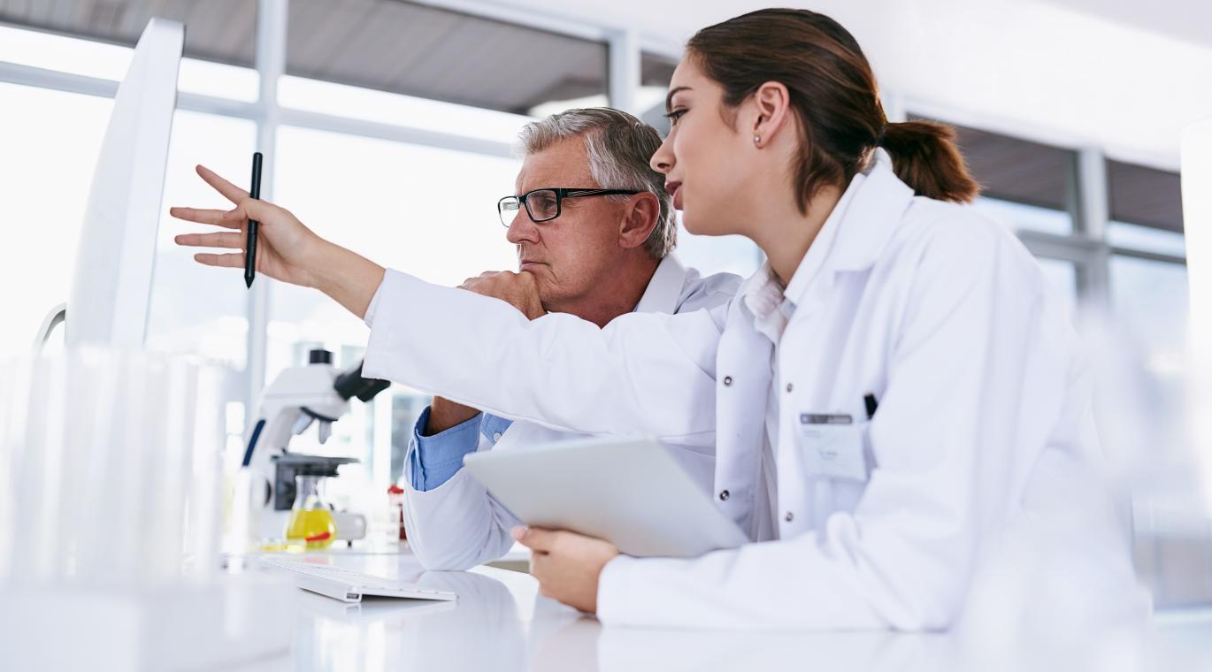 two physicians looking at a monitor